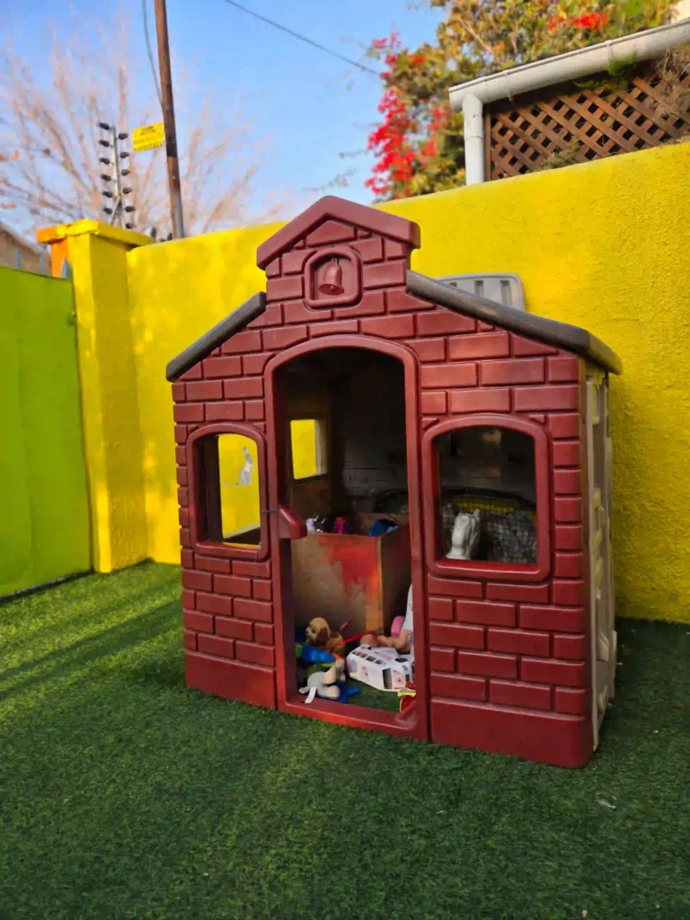 Casita de juegos en patio infantil para actividades recreativas al aire libre