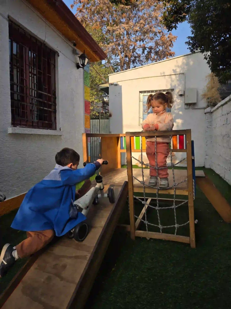 Niños desarrollando habilidades motoras en estructura de juego exterior